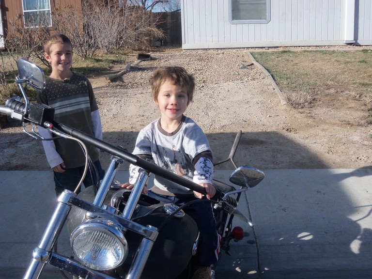 my boys Harley on the bike and Sky behind it